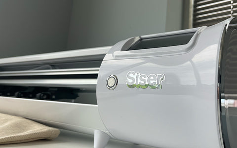 A Siser Romeo vinyl cutter sits in a shop space