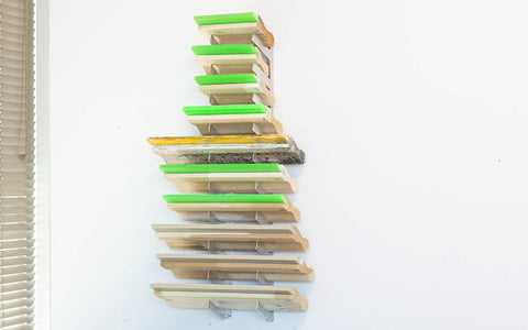squeegees sit on a rack against a wall