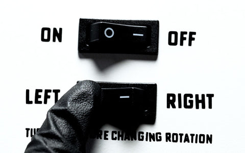 hand flipping a switch on the revolvink mixer