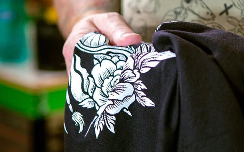 a white ink printed on a black shirt