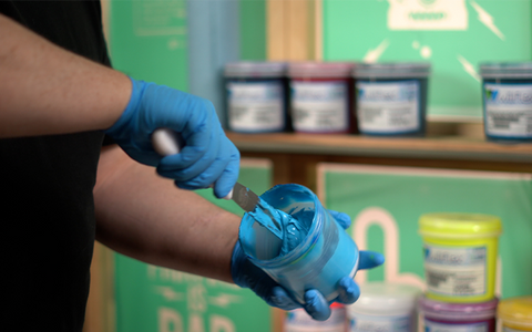 person mixing light blue ink