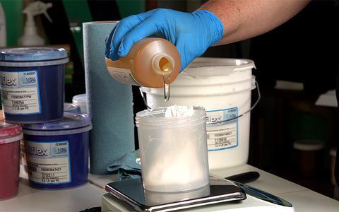 person pouring hugger catalyst into ink