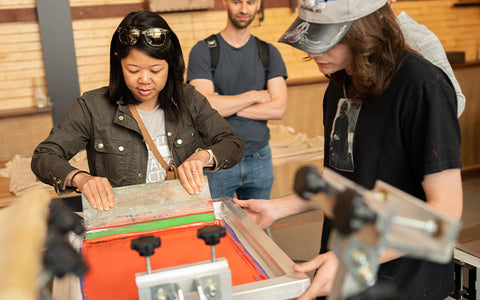 people printing on a manual press