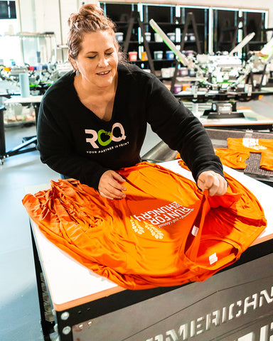 Ryonet employee with Run For The Hungry shirts