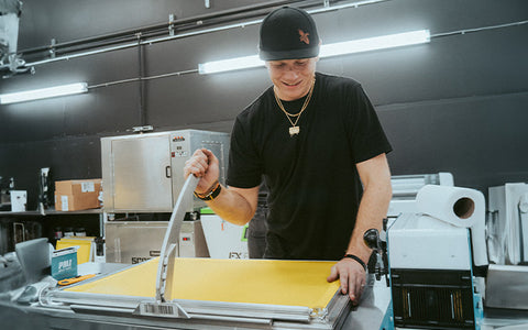 Screen Printer is installing mesh into an Eco Frame