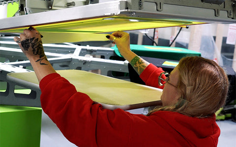 Ryonet Employee taping a screen on a ROQ Auto press