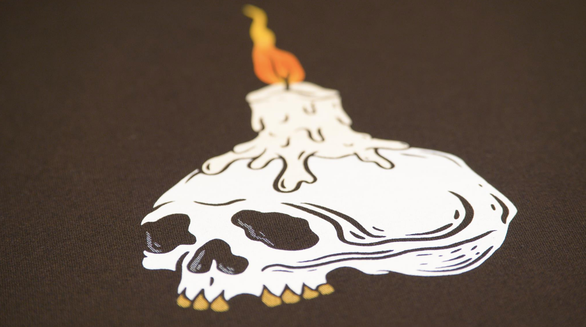 print of candle burning on a skull