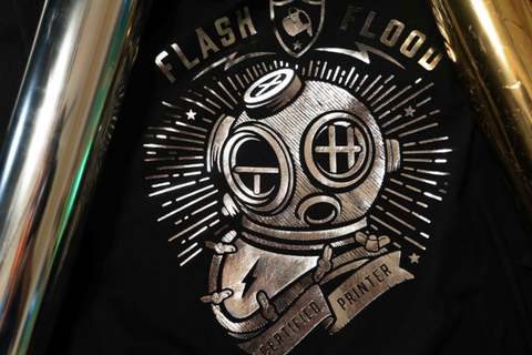 a silver foil print of a submarine suit on a black shirt