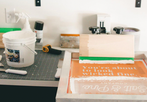 A screen printing setup with ink on a screen