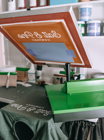 A lifted screen with flash dryer and printed shirt