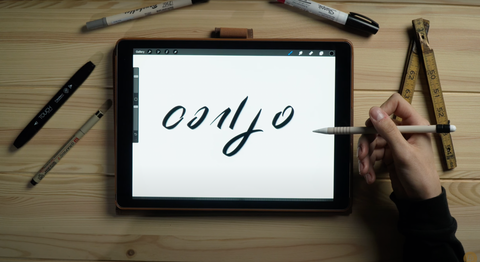 A hand draws 6 basic shapes in hand lettering