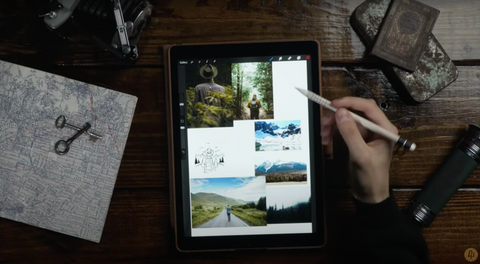 A hand holding a pen points at a tablet screen filled with images