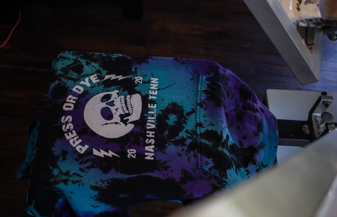 a skull printed on a tie-dyed shirt