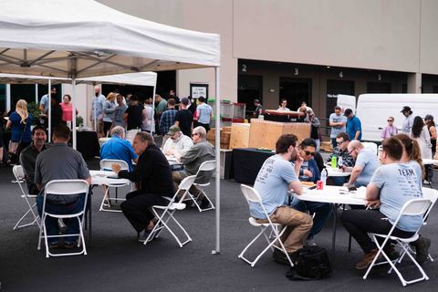 people sitting at tables outside a building