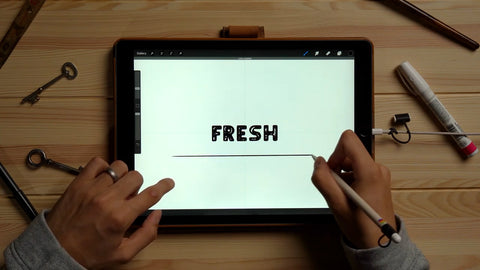 A hand draws a line under the word "Fresh"