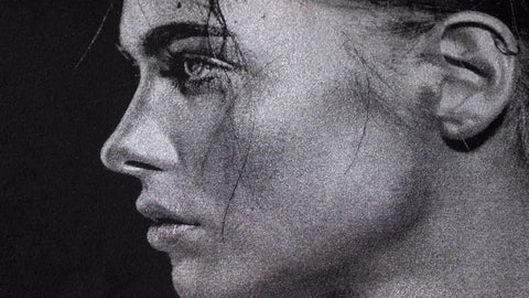 An image of the profile of a woman's face printed with silver ink