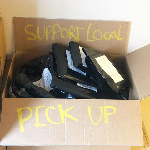 Support Local shirts in a box advertising pickup