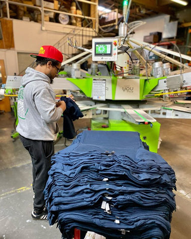 a printer loading a shirt on a roq automatic press