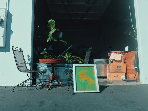 A screen sits in the sun outside a shop