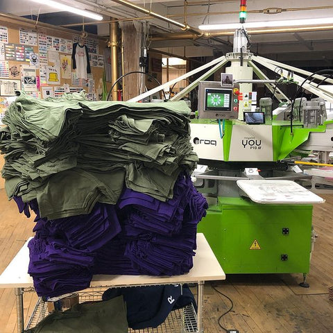 a stack of shirts by a roq press