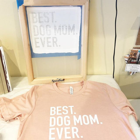 una pantalla sobre una camisa que dice la mejor madre de perro