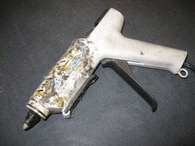 Crud covered hot-glue gun