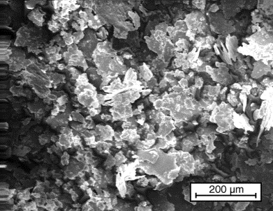 Flake-shaped aluminum metal powder particles, magnified 100 times