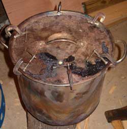Lid secured on charcoal making stock pot
