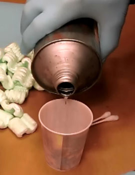 pouring methylene chloride into a cup