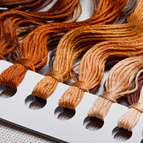 Color card for embroidery floss in warm browns.