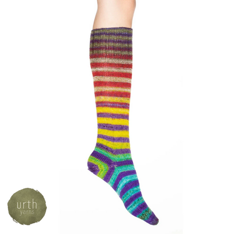 A rainbow striped sock fading from red near the knee to blue near the toe.