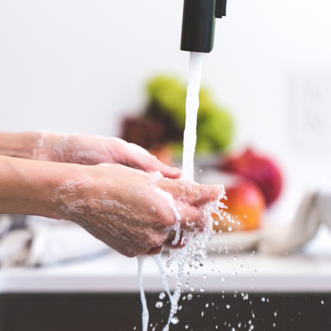 Hands being washed under running water.