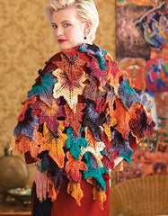 Shawl made of knit leaves in reds, oranges, yellows and greens.