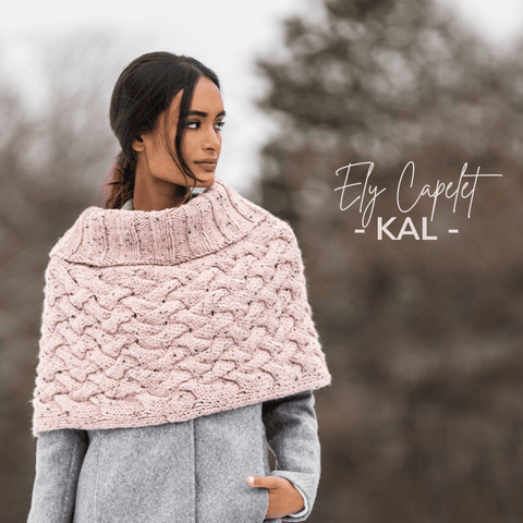 Light pink cabled capelet with ribbed cowl neck.