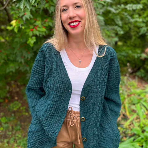 Megan wearing her Woodlore pattern knit in a rich green color.