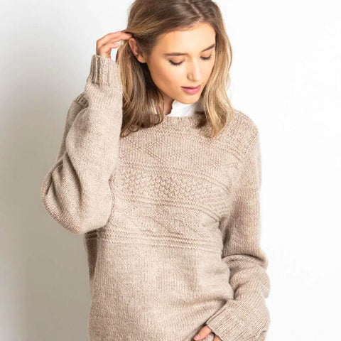 Cream colored, textured knit sweater.