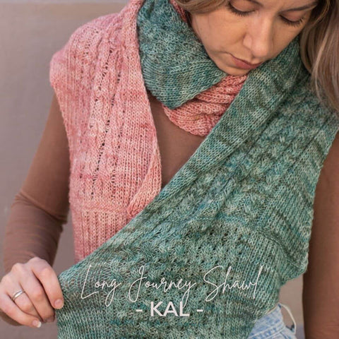 Two-colored, cabled shawl in link pink and soft blue green.