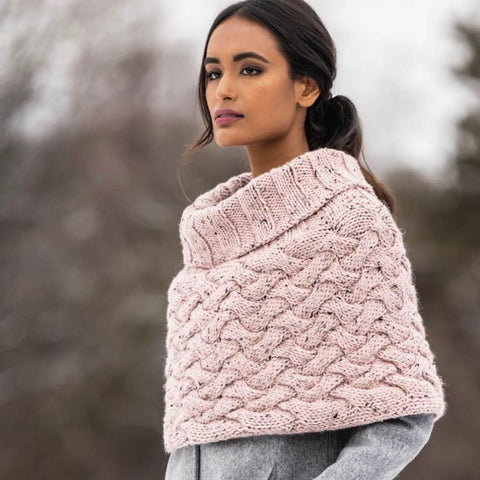 Light pink cabled capelet with cowl neck knit in Blue Sky Fibers' Woolstok Tweed.