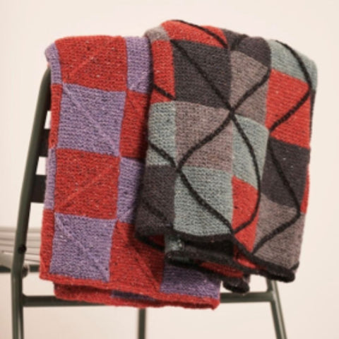 Folded Textured Tiles Sweaters on the back of a chair.