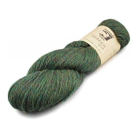 Skein of Juniper Moon Farm Herriott yarn in a heathered green color.