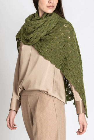 Model wearing a green lace wrap with leaf motif against a light gray background.