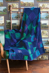 Knit blanket with squares in greens, blues and purples.