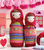 Two knit nesting dolls in reds, greens and purples.