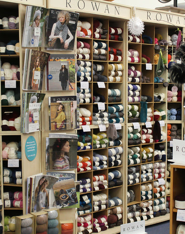 Rowan display at one of its flagship stores featuring magazines and shelves of yarn.