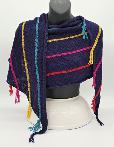 Knit shawl in navy blue with colorful stripes wrapped around a bust.