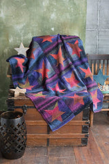 Knit blanket with stars motif in blues and reds.