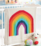 Bright knit blanket with a rainbow on cream background.