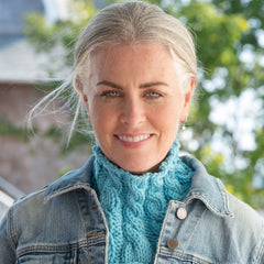 Bright teal blue knit cowl modeled with a jean jacket.
