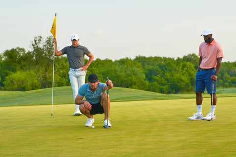 golfer lining up their putt in their golf group