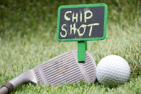 golf club and golf ball with chip shot sign